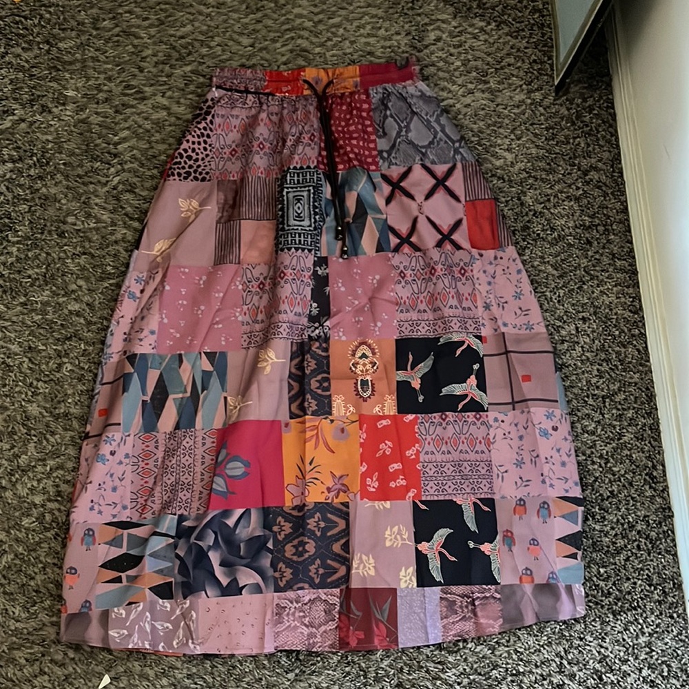 Long, thin, multicolored draw string skirt. It’s made for smaller waists.